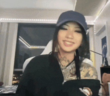 a woman with a tattoo on her arm wearing a hat