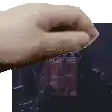 a pixelated image of a hand holding a piece of paper with the word play on it .