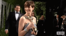 Anne Hathaway Winner GIF - Anne Hathaway Winner Grammy Award GIFs