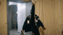 a person is doing a split while holding a green bottle