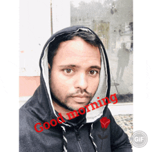 a man wearing a hoodie says good morning in red