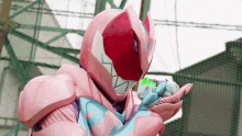 a person in a pink and purple costume is holding something in their hand