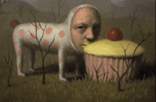 a painting of a dog eating a cupcake with an apple on top