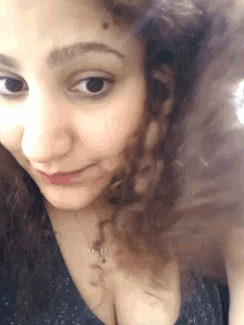 a woman wearing a necklace that says love on it
