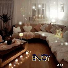 a living room with a couch and candles and the word enjoy on the bottom