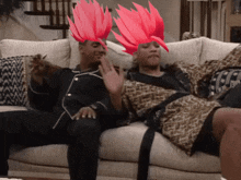 a couple of people sitting on a couch with red hair