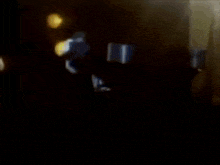 a blurry picture of a person in a dark room with a light shining on them