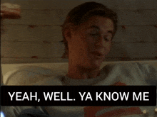 a man laying on a bed with a rolling stones shirt on says " yeah well ya know me "