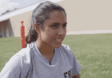 a girl wearing a grey shirt that says fbi