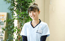 a woman wearing a name tag that says ' a ' on it smiles