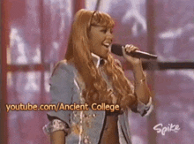 a woman singing into a microphone with youtube.com/ancient college written on the bottom