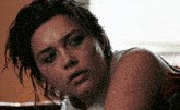 a close up of a woman 's face with a white shirt on
