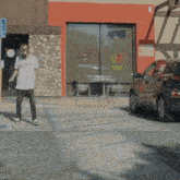 a man wearing a shirt that says kill tom is dancing