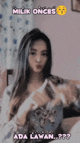 a woman making a face with the words milik onces ada lawan