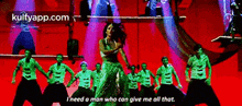 a woman is dancing in front of a group of men with the words i need a man who can give me all that