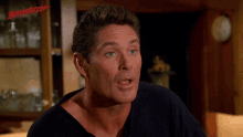 a close up of a man 's face with the word baywatch on the bottom right