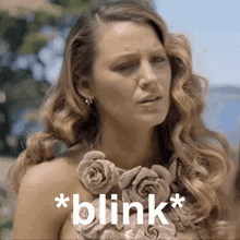 a woman with a necklace of roses and the words * blink * on the bottom
