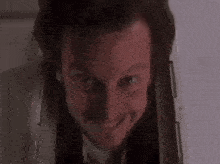 a close up of a man 's face with a smile on his face .