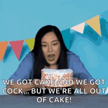 a woman is sitting in front of a cake that says " we got cake and we got cock ... but we 're all out of cake "