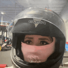 a woman wearing a goen helmet looks at the camera