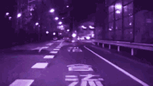 a blurry picture of a street with a sign that says ' t.e. '