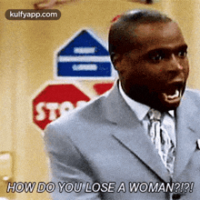 a man in a suit and tie is yelling at a woman .