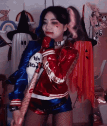 a woman in a harley quinn costume holds a bat in her hand