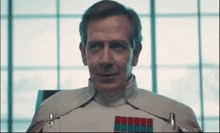 a man in a star wars uniform looks up at the camera