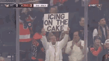 sign guy sign man philadelphia flyers flyers icing on the cake