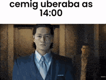 a man in a suit and tie is standing in front of a sign that says " cemig überaba as 14:00 "
