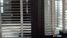 a picture of a window with blinds and the words law and order on the bottom