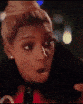 a close up of a woman 's face with a shocked look on her face