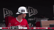 a baseball player wearing a white hard hat with the word angels on it