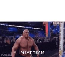 a large muscular man is standing in a wrestling ring with the words `` meat team '' written on the bottom .