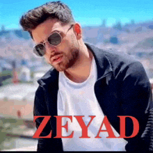 a man wearing sunglasses and a black jacket has the name zeyad on the bottom