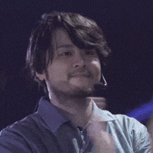 a man with a beard wearing a microphone on his head