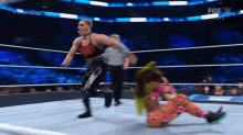 two women are wrestling in a ring with the fox logo on the bottom
