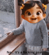 a little girl is standing in front of a window with a caption that says " no it 's a fucking goat "