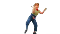 a woman in a green shirt and jeans is dancing