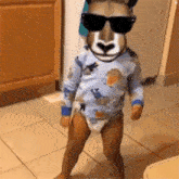 a baby wearing sunglasses and a llama mask is standing on a tiled floor
