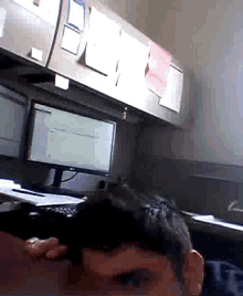 a man sitting at a desk with a computer and a keyboard