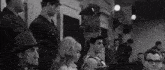 a black and white photo of a group of people in a courtroom with a speech bubble that says `` miluji vas '' .