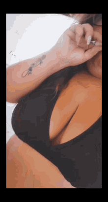 a woman with a tattoo on her wrist that says " i love you "
