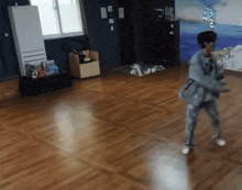 a person is dancing in a room with a wood floor