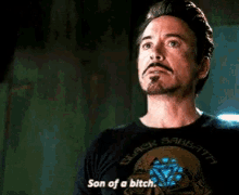 a man with a beard is wearing a black shirt that says son of a bitch