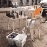 a few tables and chairs with bottles of alcohol on them