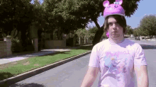 a person wearing a pink shirt that says magical on it