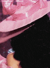 a close up of a person wearing a pink hat with tumblr written in the corner