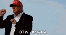 donald trump is wearing a red hat and a suit and is making a funny face .