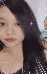a close up of a woman 's face with a pink star in her hair